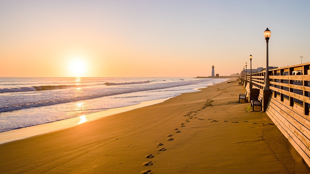 Virginia Beach boardwalk stretching along the golden sand at sunrise